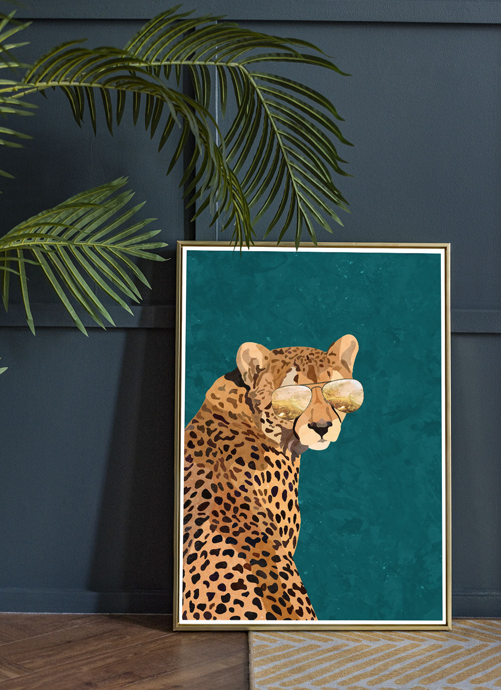 Cool Cheetah Art Print by Sarah Manovski in a room with a plant and navy blue panelled wall